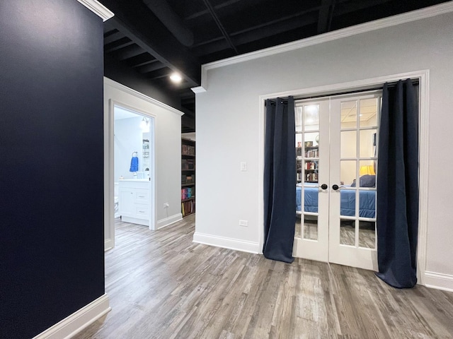 unfurnished room featuring french doors, baseboards, and wood finished floors