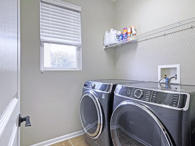 laundry room featuring washer and dryer, baseboards, and laundry area