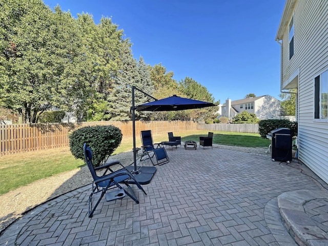 view of patio / terrace with a fenced backyard and a grill