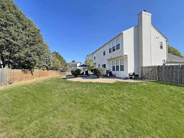 view of yard featuring a patio and a fenced backyard