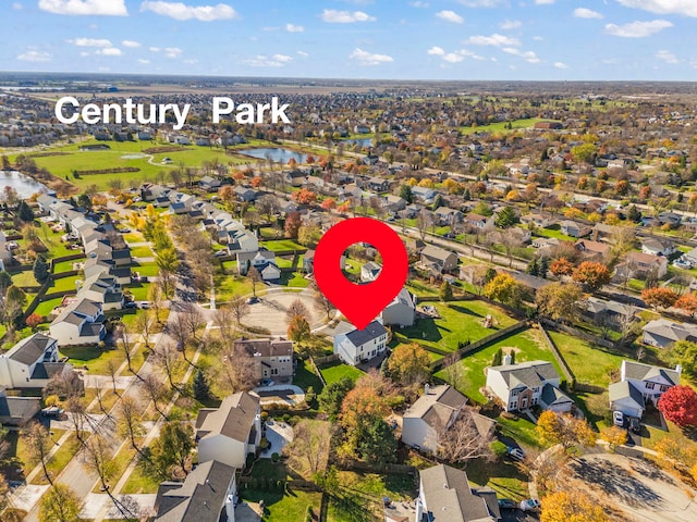 drone / aerial view featuring a residential view and a water view