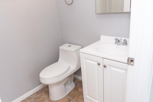 bathroom featuring tile patterned flooring, vanity, and toilet