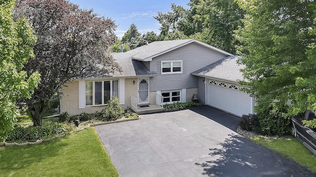 split level home with a front yard and a garage