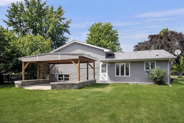 rear view of house featuring a yard and a patio area