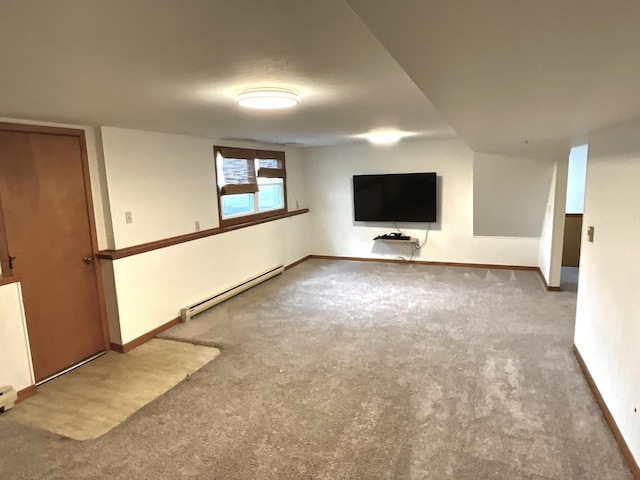 basement featuring carpet and a baseboard heating unit