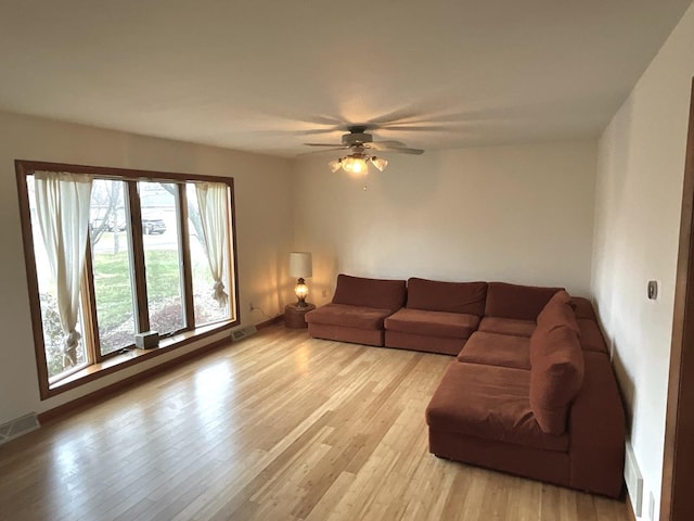 living room featuring ceiling fan and light hardwood / wood-style flooring