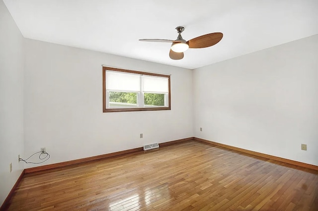 empty room featuring ceiling fan and light hardwood / wood-style flooring