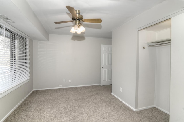 unfurnished bedroom with ceiling fan, light carpet, and a closet