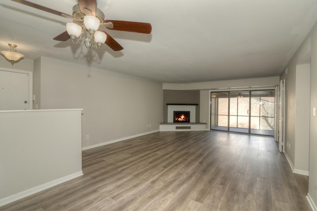 unfurnished living room with hardwood / wood-style flooring and ceiling fan