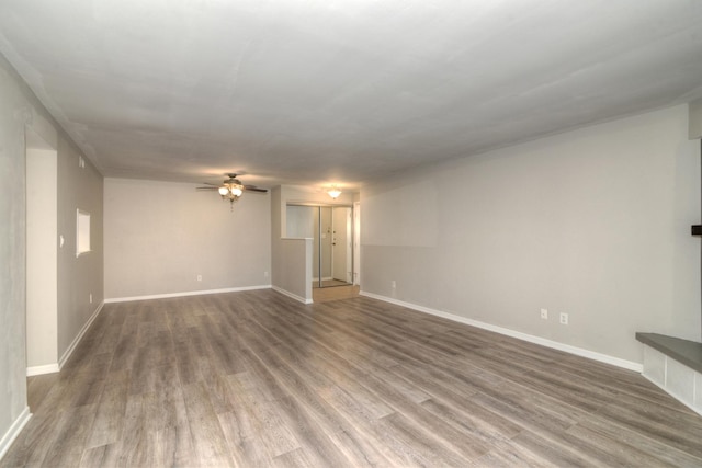 unfurnished living room featuring hardwood / wood-style floors and ceiling fan