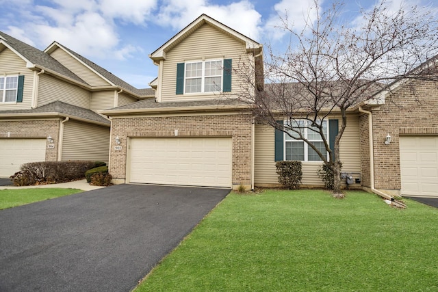 view of front of property with a garage and a front yard