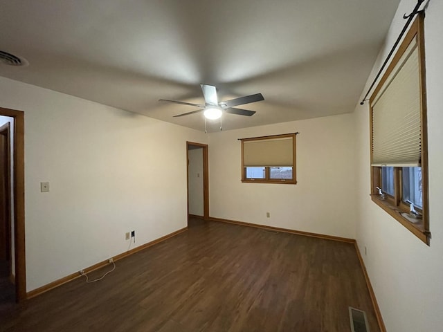 spare room featuring dark hardwood / wood-style floors and ceiling fan