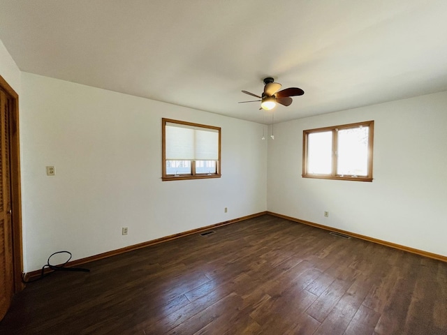 unfurnished room with ceiling fan and dark hardwood / wood-style flooring