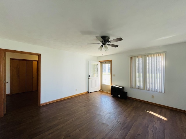 empty room with ceiling fan and dark wood-type flooring