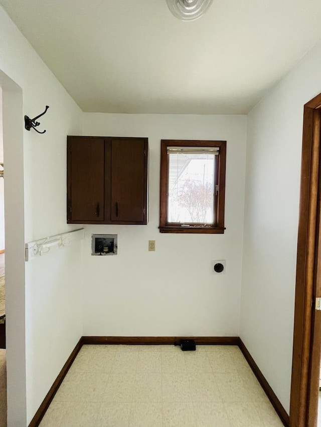 clothes washing area featuring hookup for a washing machine and cabinets