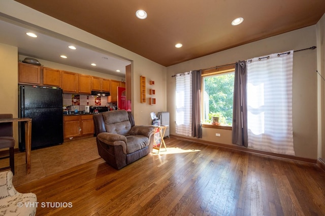 living room with wood-type flooring and radiator heating unit