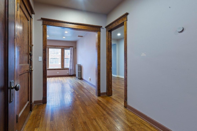 corridor featuring dark hardwood / wood-style floors and radiator