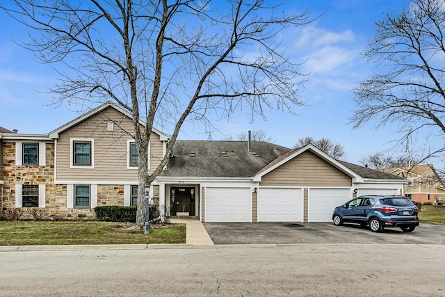 view of front of house with a front yard and a garage