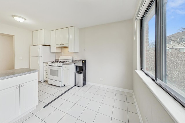 kitchen with white cabinetry, light tile patterned flooring, and white appliances