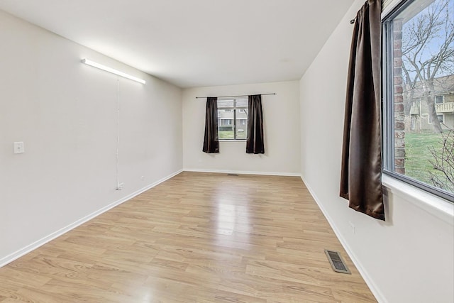 spare room featuring light hardwood / wood-style flooring