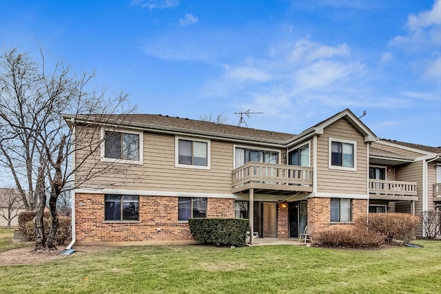 rear view of property featuring a lawn and a balcony