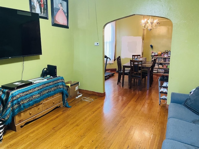 living room with wood-type flooring and an inviting chandelier