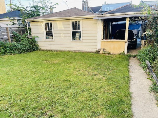 rear view of property with a lawn