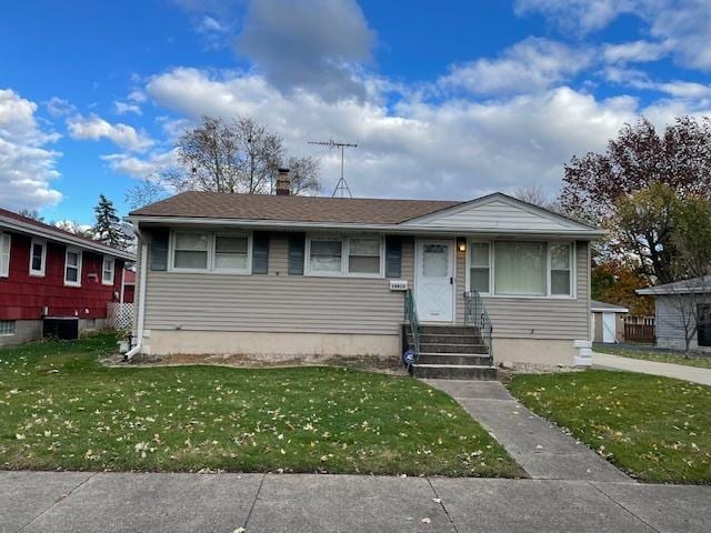 bungalow-style house with a front yard