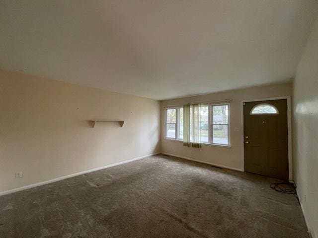 entrance foyer featuring dark colored carpet