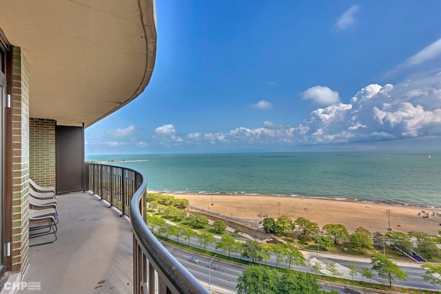 balcony with a beach view and a water view