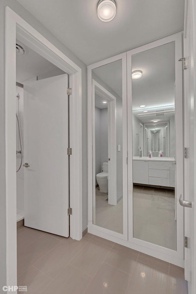 bathroom with tile patterned floors, vanity, and toilet