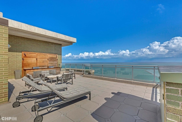 view of patio / terrace with an outdoor living space and a water view