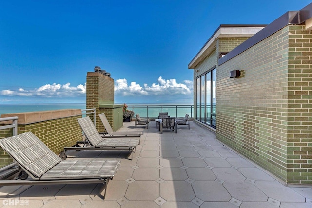 view of patio featuring a water view