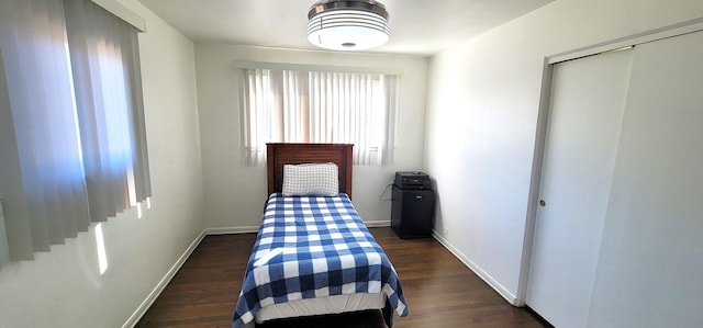 bedroom featuring dark hardwood / wood-style flooring and a closet