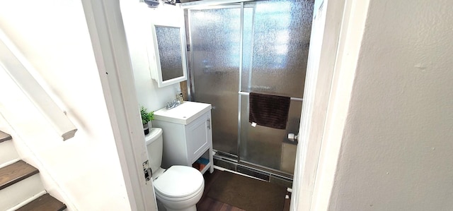 bathroom with vanity, toilet, and walk in shower