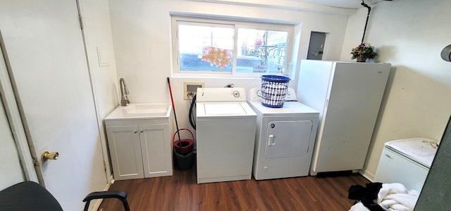 clothes washing area featuring washer and dryer, cabinets, dark wood-type flooring, and sink