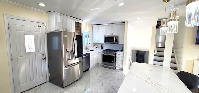 kitchen with sink, decorative light fixtures, light stone counters, white cabinetry, and stainless steel appliances