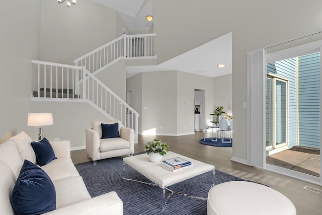 living room featuring a high ceiling and dark hardwood / wood-style floors