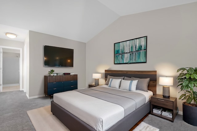 bedroom featuring light carpet and lofted ceiling