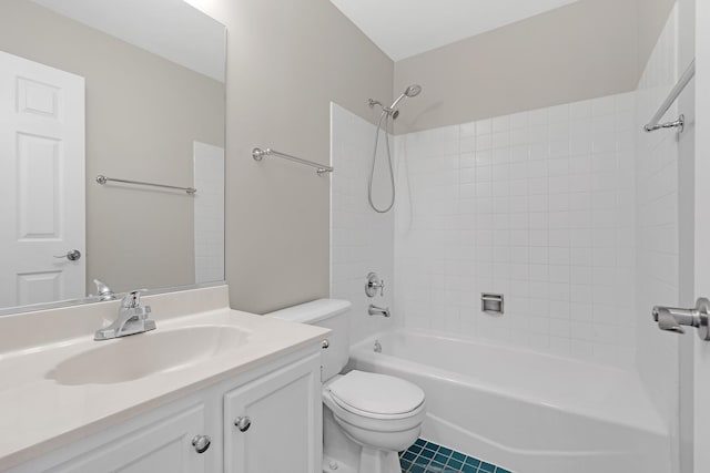 full bathroom featuring vanity, tiled shower / bath, and toilet