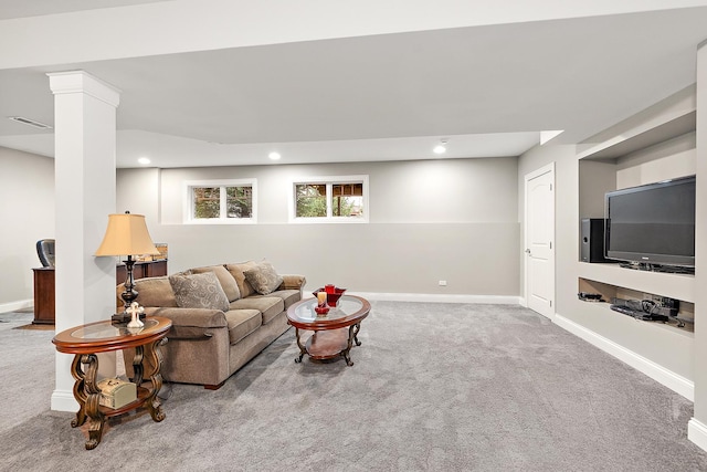 carpeted living room featuring decorative columns