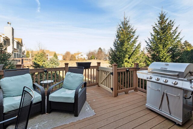 wooden deck featuring area for grilling