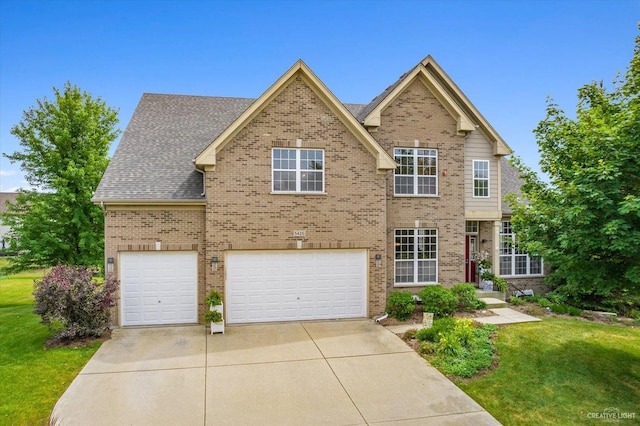 view of front of house with a garage and a front lawn