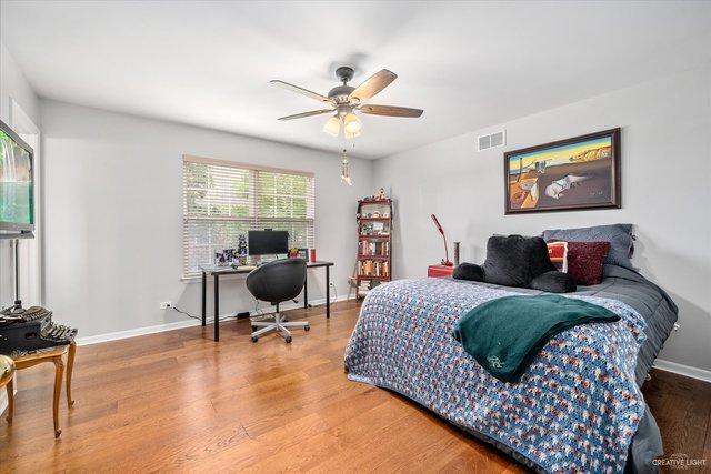 bedroom with hardwood / wood-style flooring and ceiling fan