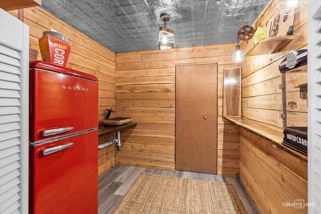 interior space with wood-type flooring and wooden walls