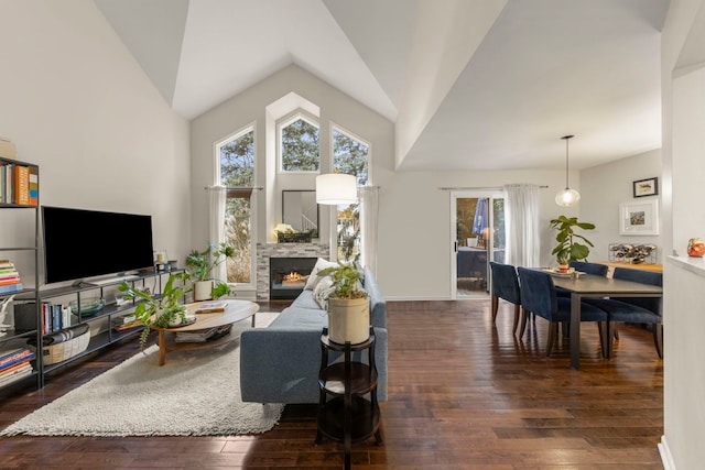 living room with a fireplace, high vaulted ceiling, and dark hardwood / wood-style floors