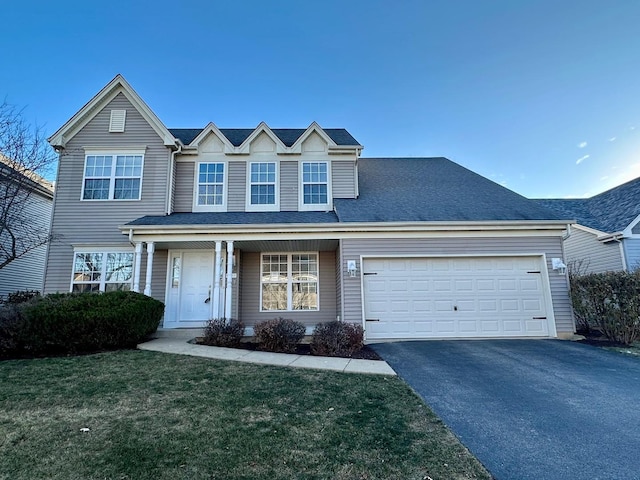 view of front of house with a front yard and a garage