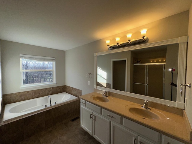 bathroom with plus walk in shower, vanity, and tile patterned floors