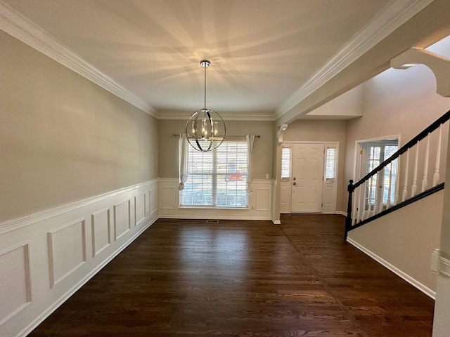 foyer featuring a notable chandelier, crown molding, and dark wood-type flooring