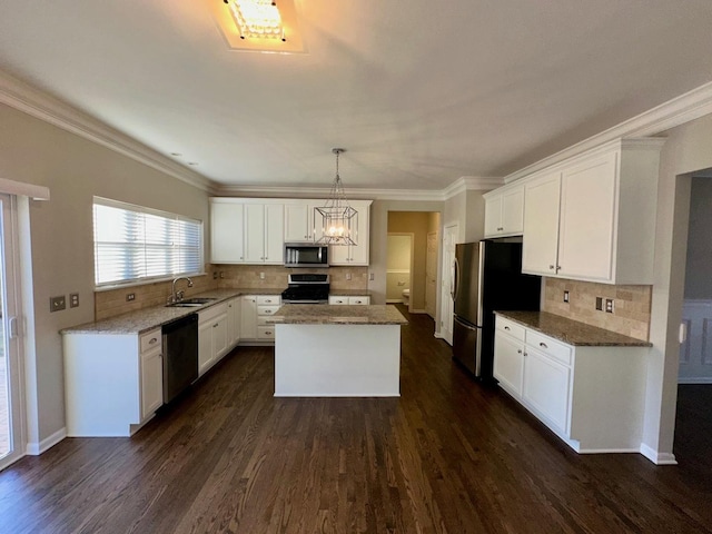 kitchen with a center island, white cabinets, sink, dark hardwood / wood-style flooring, and stainless steel appliances